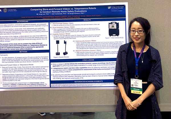 Dr. Lee smiles and stands in front of her poster.