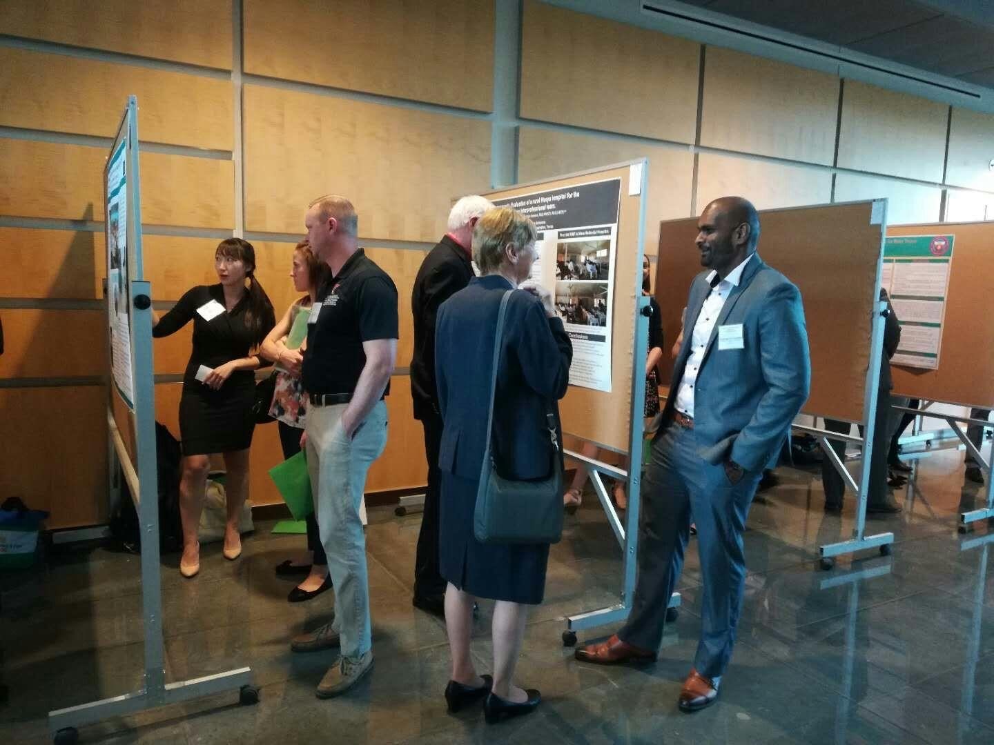 Dr. Raj Rajendran addressing conference guests in front of his poster